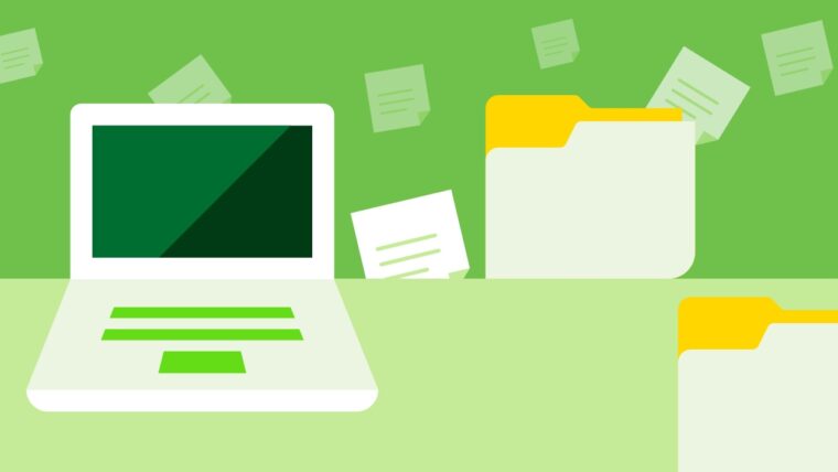 Komputer i dokumenty na zielonym tle